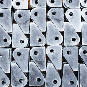 Galvanized metal products with holes for securing cargo on the deck of a cargo ship.